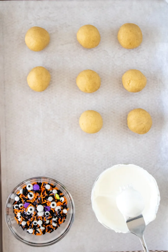 Fork lifting a coated cake truffle from melted candy coating with excess dripping off