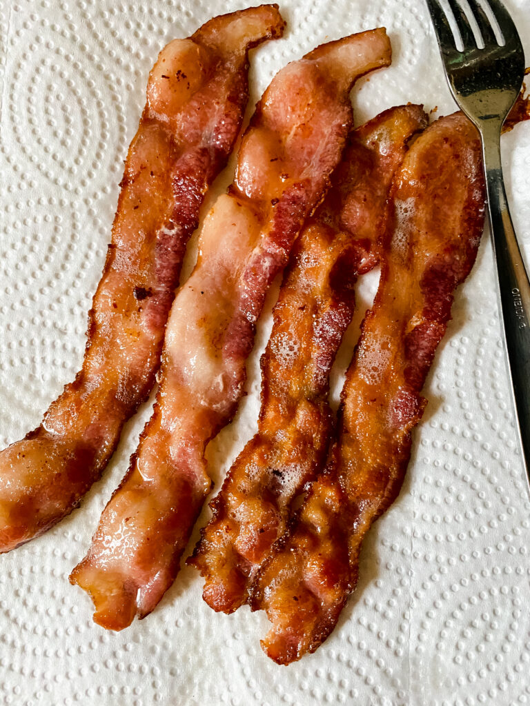 bacon hot off the stove draining on paper towels
