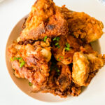 Golden brown buttermilk fried chicken with a crispy, seasoned crust and juicy, tender meat served hot for the perfect Southern-style comfort meal.