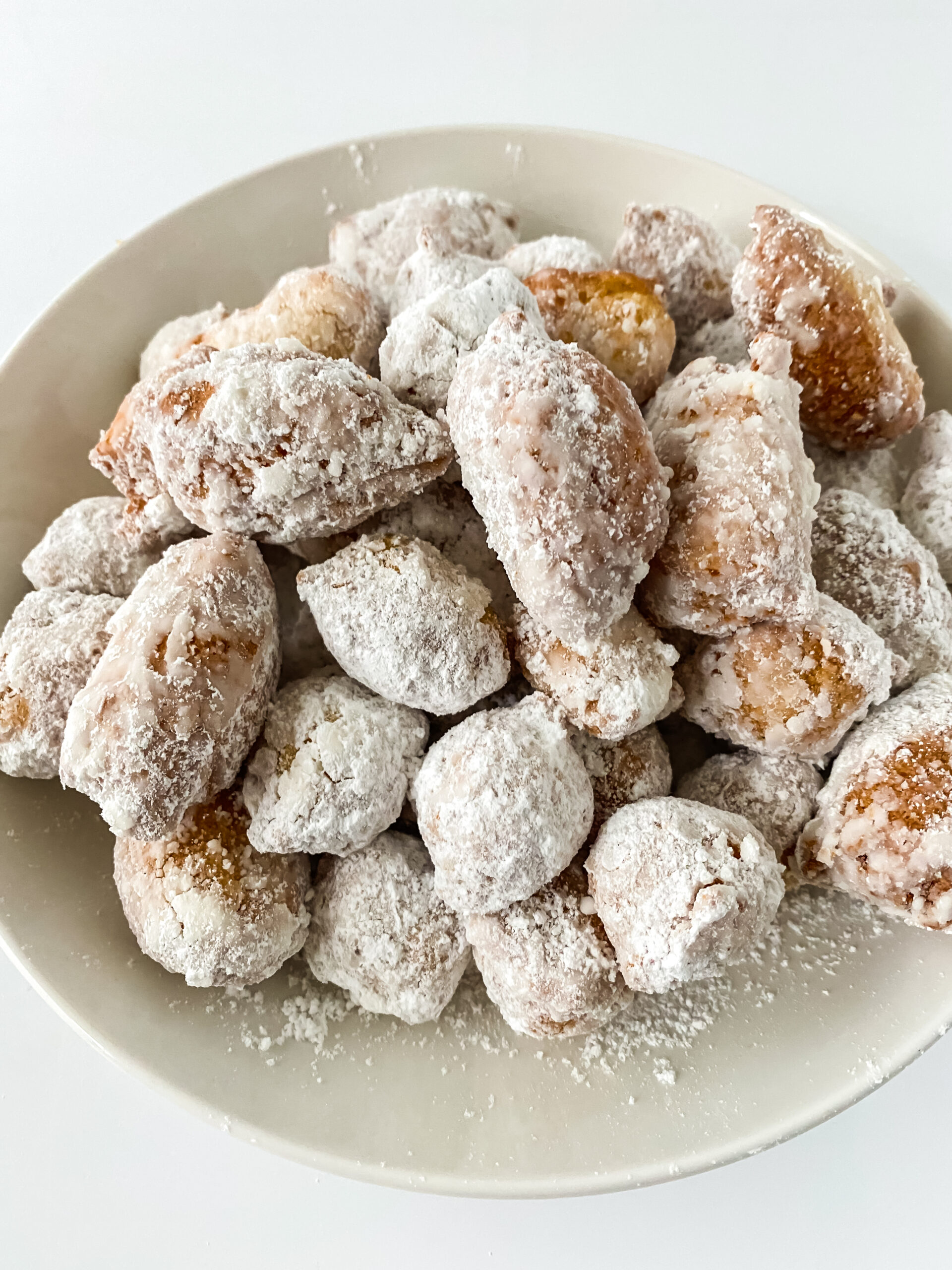 cinnamon sugar donut holes on a white plate