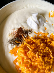 Finished homemade cheese sauce stirred until smooth and creamy for easy baked macaroni and cheese.