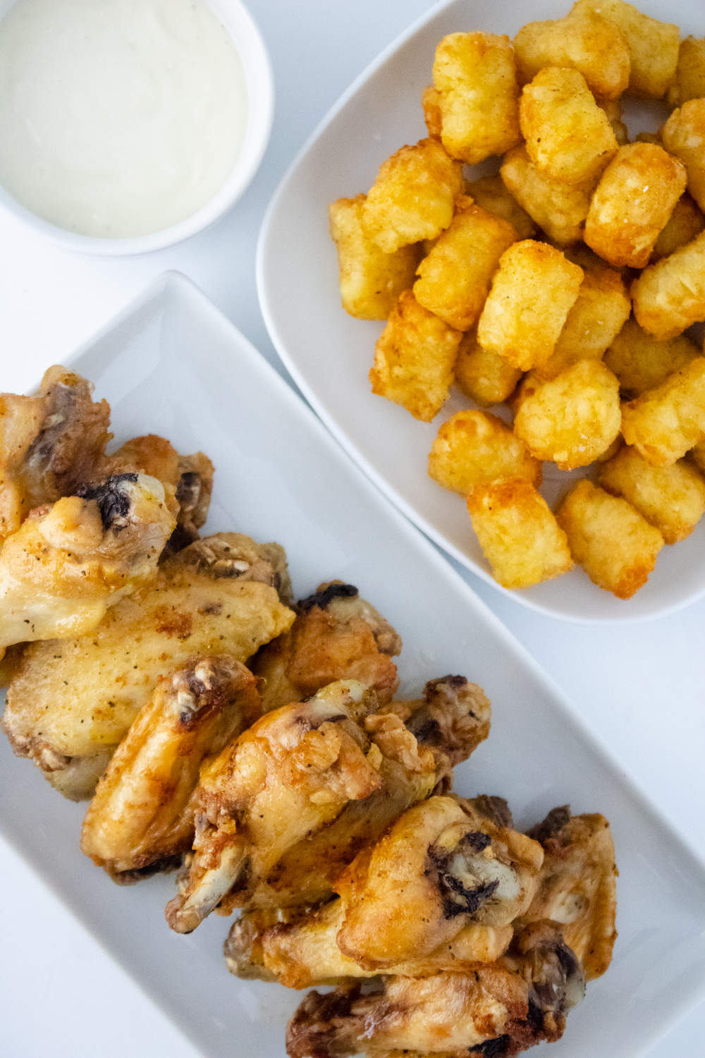 Copycat Buffalo Wild Wings lemon pepper wings served with crispy tater tots and ranch dipping sauce.