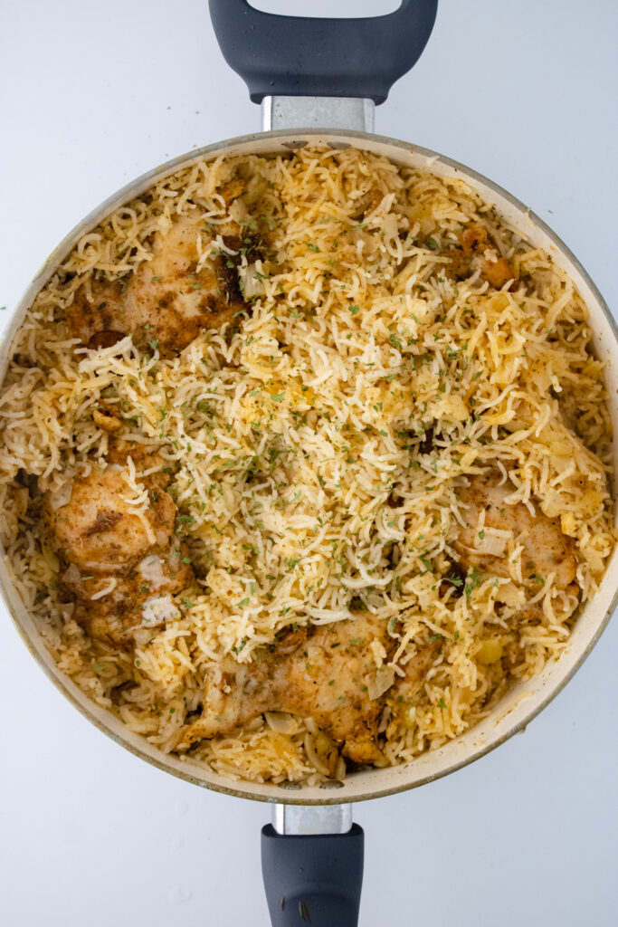Finished one pot chicken and rice with tender chicken thighs and fluffy basmati rice cooked together in a skillet.