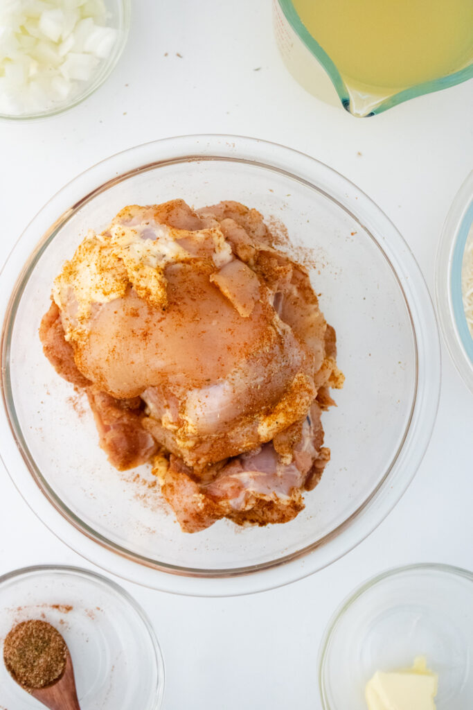 Boneless chicken thighs coated with a homemade seasoning blend before cooking one pot chicken and rice with basmati rice.