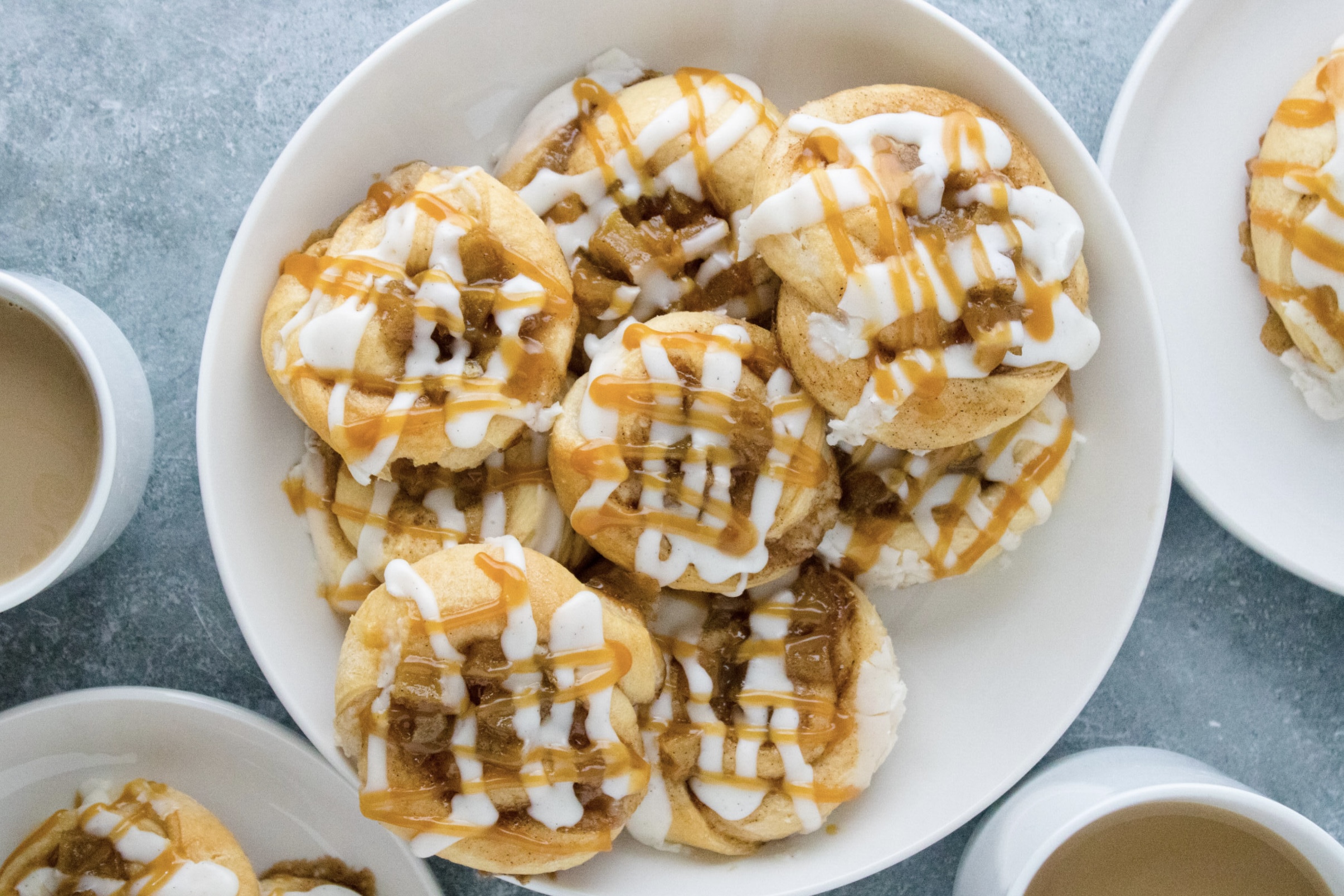 Easy caramel apple Danish made with refrigerated crescent sheet dough, cream cheese filling, cinnamon apples, icing, and caramel drizzle.