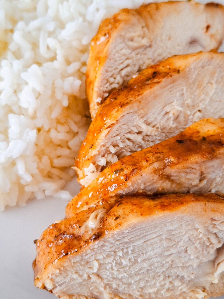 honey glazed chicken on a white plate with white rice