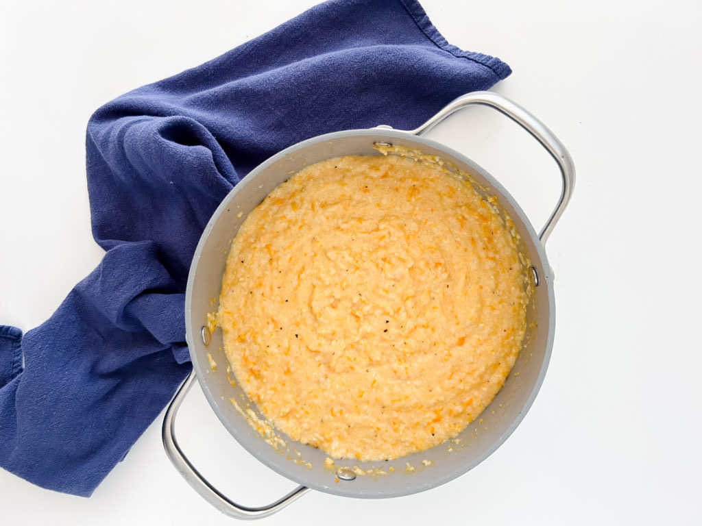 Creamy sweet potato grits in a large pot ready to serve.