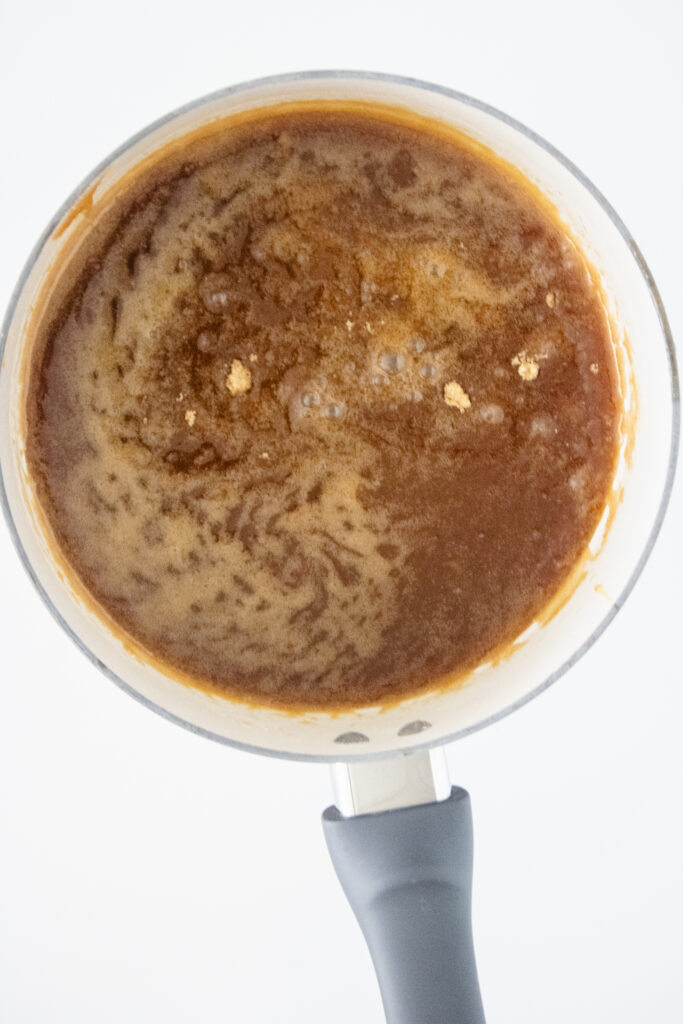 honey baked chicken sauce cooking in a white pot