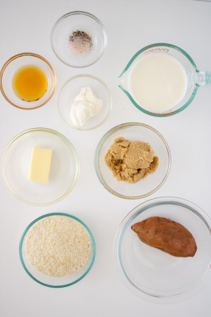 Ingredients for sweet potato grits including grits, sweet potato, cream, brown sugar, and maple syrup