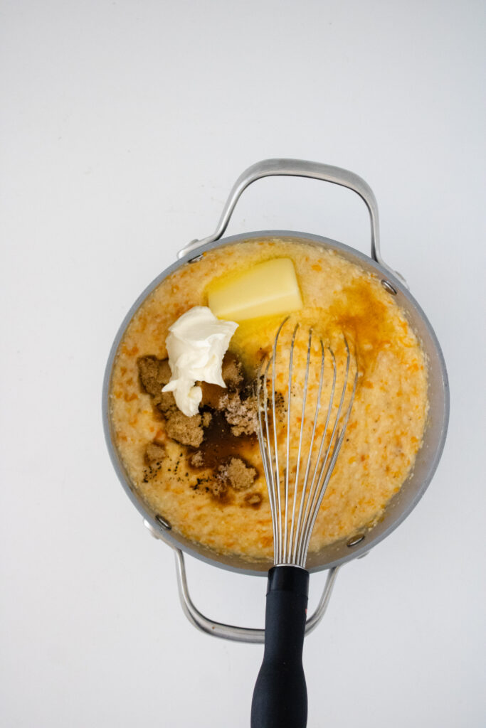 Sweet potato, cream cheese, butter, brown sugar, and maple syrup being added to cooked grits