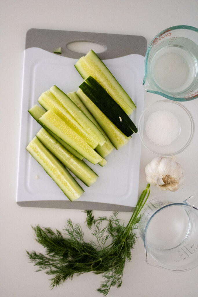 ingredients for Homemade Kosher Dill Pickles on a white board