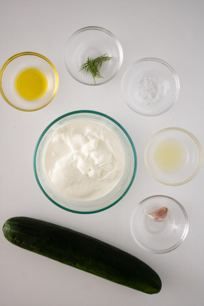 ingredients for greek sauce on white board