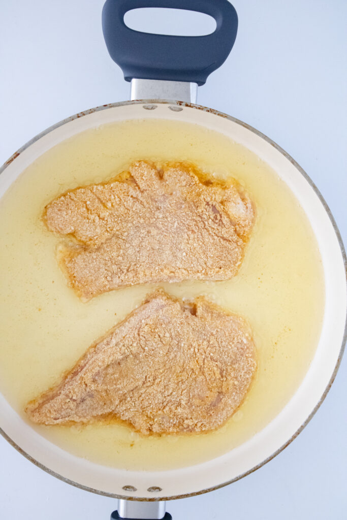 Pan frying chicken cutlets for Crunchy Chicken Caesar Sub
