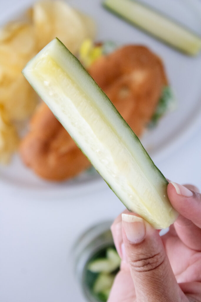 Homemade Kosher Dill Pickles in focus sandwich blurred out