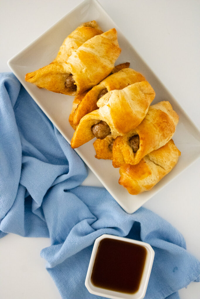 breakfast pigs in a blanket on a white plate