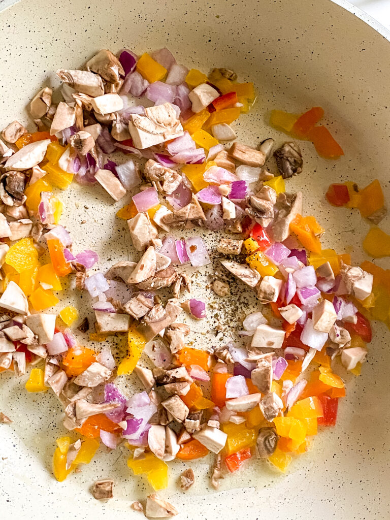 diced vegetables cooking in a pan