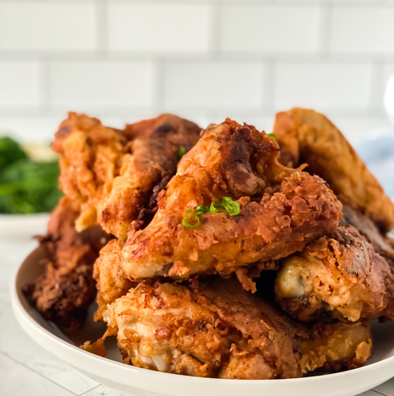 Golden brown buttermilk fried chicken with a crispy, seasoned crust and juicy, tender meat served hot for the perfect Southern-style comfort meal.