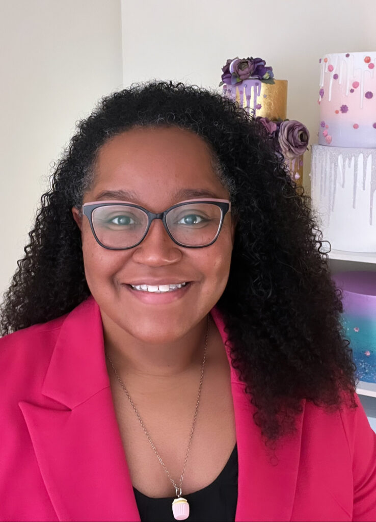 Cydni Mitchell Hodges of Sweet Fest, business strategist for creative entrepreneurs and new owner of The Affordable Foodie recipe blog, in a professional headshot wearing a pink blazer.