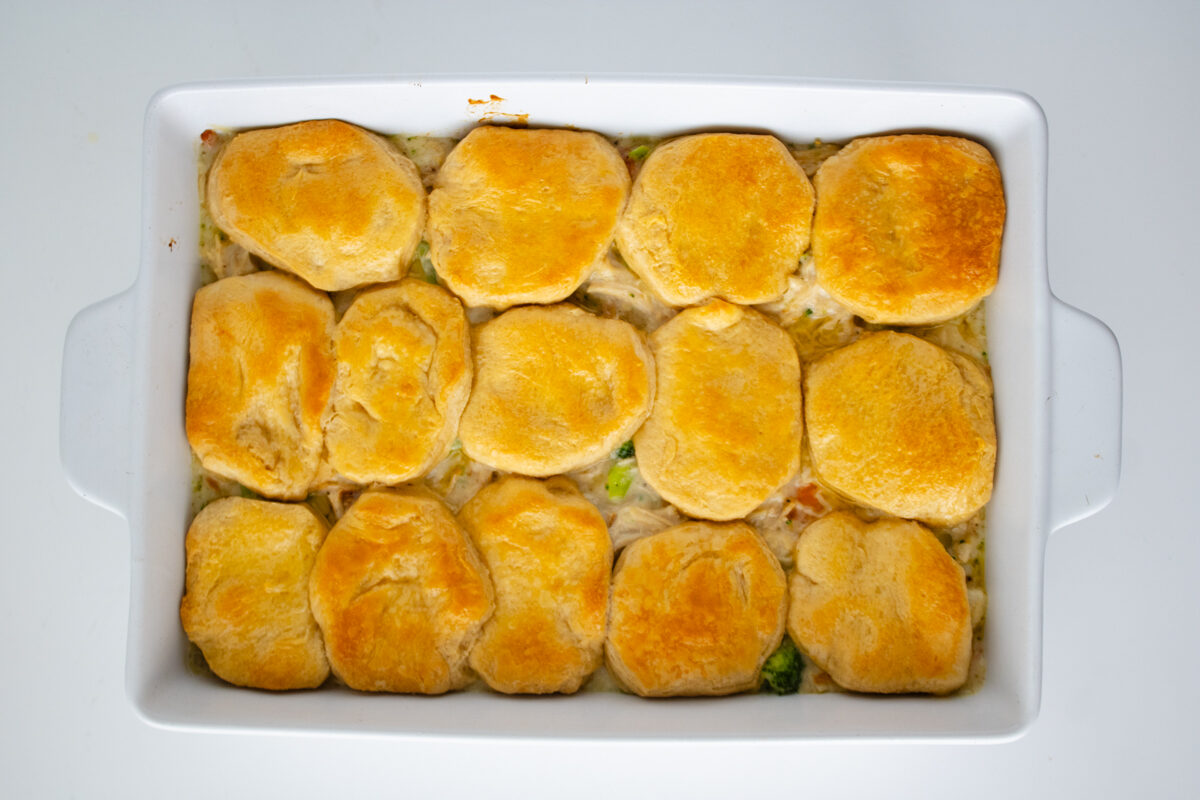 Chicken pot pie with biscuits baked until golden brown in a casserole dish.
