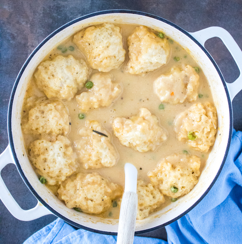Fluffy Cheddar Bay dumplings finished cooking in a thick, creamy chicken and dumplings broth.