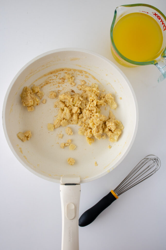 Roux made with butter, flour, onions, and garlic in a skillet for chicken pot pie filling.