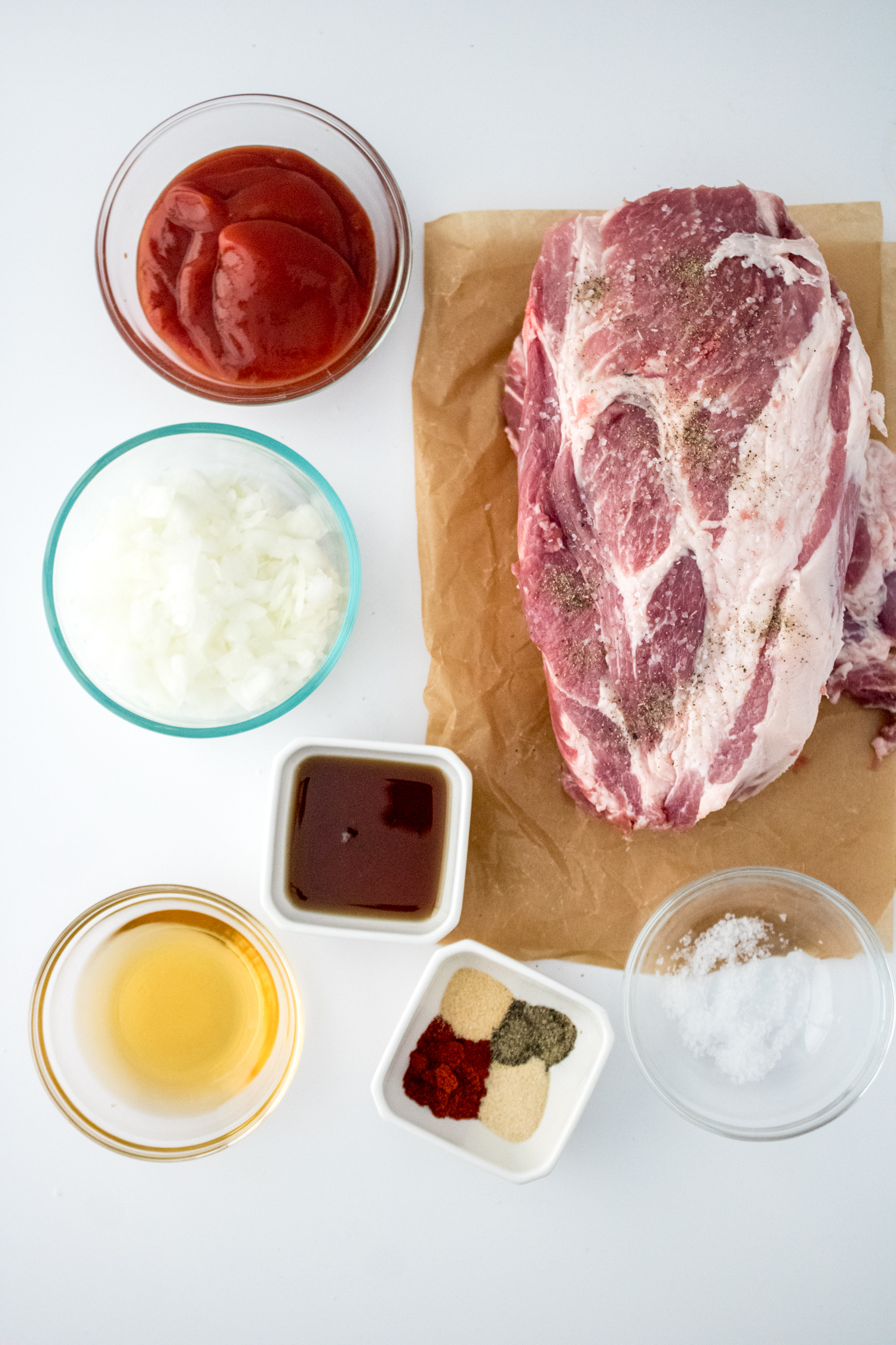 Pork shoulder seasoned with salt and black pepper for Crock Pot BBQ Pulled Pork.