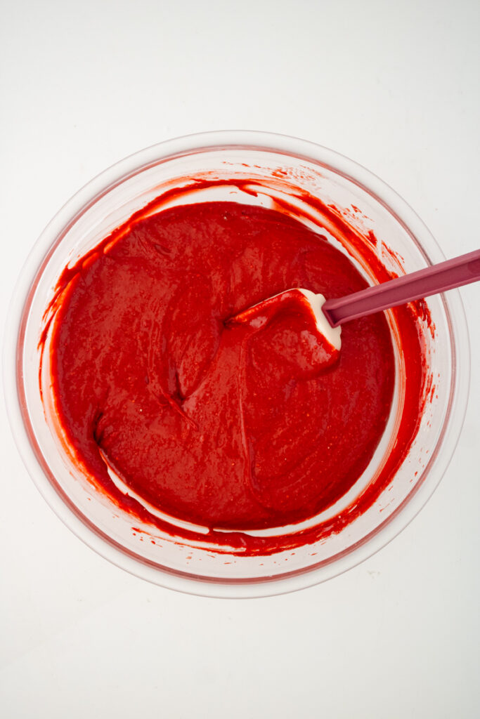 Thick red velvet cupcake batter mixed until smooth and well combined.