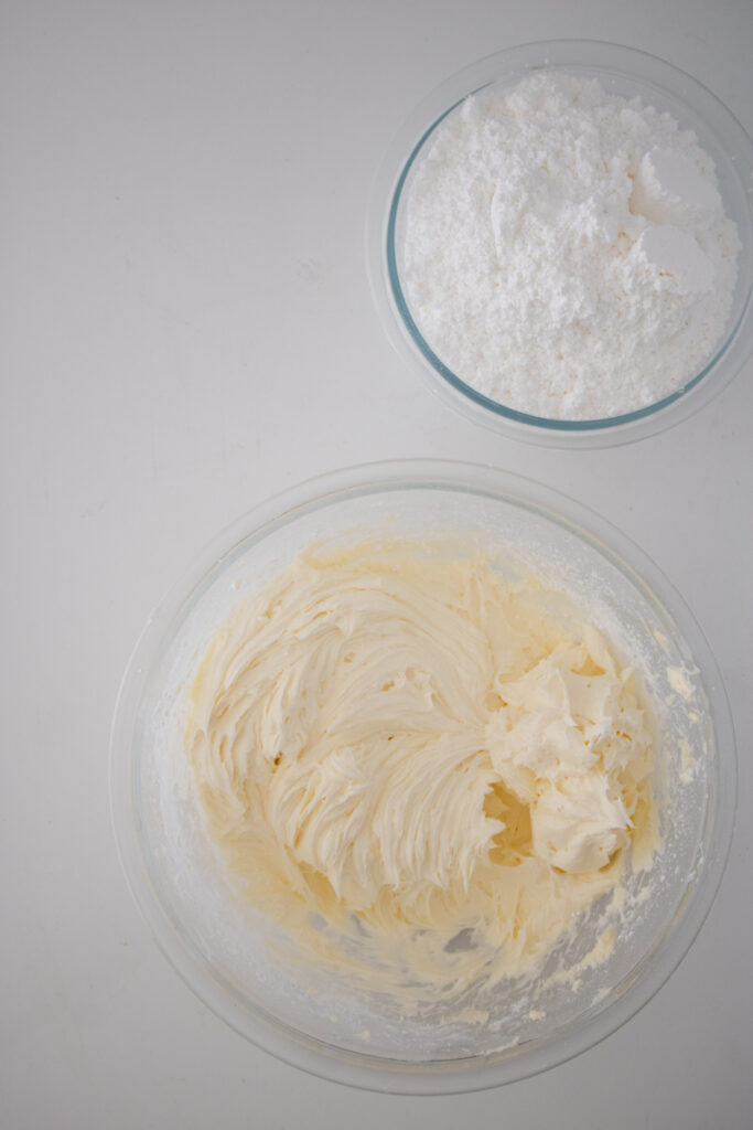 Cream cheese frosting being mixed before the powdered sugar is added.
