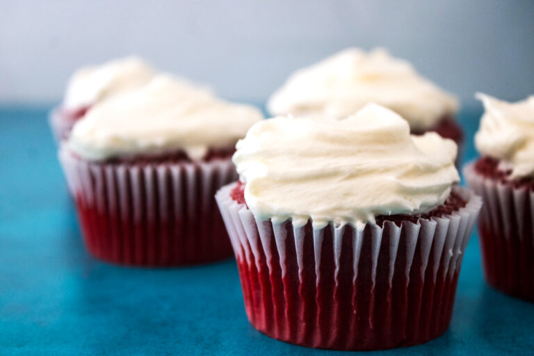 Red velvet cupcakes made from box mix topped with homemade cream cheese frosting.