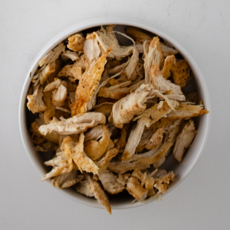 Shredded seasoned chicken for chicken and dumplings with biscuit mix.